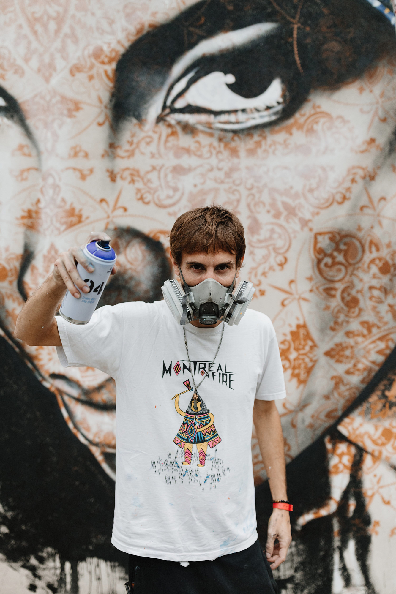 Man in front of mural